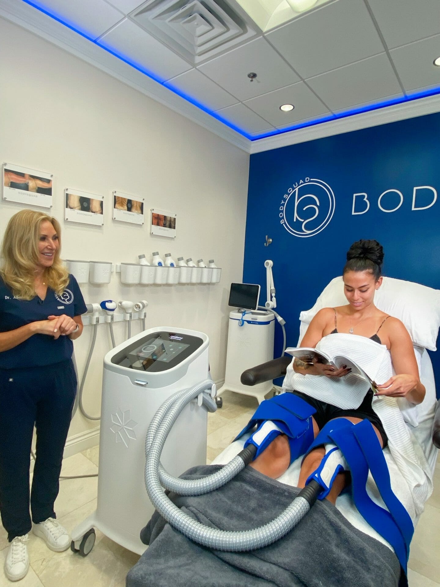 Patient at BodySquad getting their treatment done while relaxing and reading a magazine